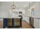 Modern kitchen featuring stainless appliances, island, granite counters, and sleek white cabinetry at 233 Surles Rd, Benson, NC 27504
