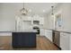 Modern kitchen featuring stainless appliances, island, granite counters, and sleek white cabinetry at 233 Surles Rd, Benson, NC 27504