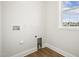 Bright laundry room with wood look floors and a window for natural light at 233 Surles Rd, Benson, NC 27504