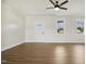 Bright living room with wood-look flooring, white trim, and a ceiling fan at 233 Surles Rd, Benson, NC 27504