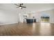 Open-concept living room flowing into the kitchen, with hardwood floors and natural light at 233 Surles Rd, Benson, NC 27504