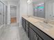 Modern bathroom featuring marble floors, double sinks, a spacious vanity, updated shower, and ample lighting at 33 Macy Cir, Wendell, NC 27591