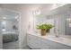 Bright bathroom with double sink vanity, quartz countertops, and view to bedroom at 33 Macy Cir, Wendell, NC 27591