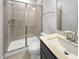 Modern bathroom featuring a glass-enclosed shower and neutral tile at 33 Macy Cir, Wendell, NC 27591