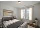 Comfortable bedroom featuring large windows, a neutral palette, and stylish decor at 33 Macy Cir, Wendell, NC 27591