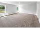 Bedroom featuring plush carpeting, two large windows for ample natural light, and neutral wall paint at 33 Macy Cir, Wendell, NC 27591