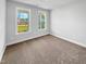 Bedroom with neutral walls and carpet featuring a view from the windows at 33 Macy Cir, Wendell, NC 27591