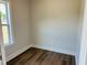 Bright bedroom with hardwood flooring and a large window at 33 Macy Cir, Wendell, NC 27591