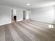 Expansive carpeted bedroom with ample closet space, neutral paint, ensuite bathroom and modern lighting at 33 Macy Cir, Wendell, NC 27591
