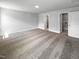 Spacious bedroom with an ensuite bathroom, walk-in closet, neutral colors, carpeted floors and modern lighting at 33 Macy Cir, Wendell, NC 27591