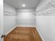 Spacious closet with ample storage, carpet flooring, shelving, and neutral paint at 33 Macy Cir, Wendell, NC 27591