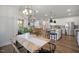 Open-concept dining area showcasing a modern chandelier and seamless transition into the kitchen and living room at 33 Macy Cir, Wendell, NC 27591