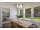 Charming dining room with a wooden table, stylish seating, and bright natural light from a large window at 33 Macy Cir, Wendell, NC 27591