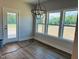 Bright dining area with modern lighting and large windows overlooking the yard at 33 Macy Cir, Wendell, NC 27591