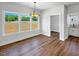 Dining room with wood flooring, large windows and modern light fixture at 33 Macy Cir, Wendell, NC 27591
