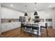 Modern kitchen with white cabinets, a center island with seating, stainless steel appliances, and stylish backsplash at 33 Macy Cir, Wendell, NC 27591