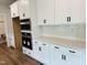 Modern kitchen features white cabinets, stainless steel appliances, and quartz countertops at 33 Macy Cir, Wendell, NC 27591