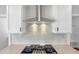 Close up view of the kitchen with sleek electric stovetop and stainless steel hood at 33 Macy Cir, Wendell, NC 27591