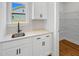 Kitchenette area with sink, sleek countertops, and ample cabinet space at 33 Macy Cir, Wendell, NC 27591