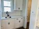 Bright kitchen features white cabinetry, quartz counters, and a stainless steel sink at 33 Macy Cir, Wendell, NC 27591