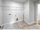 Laundry room with marble floors, neutral paint, storage shelving and appliances hook ups at 33 Macy Cir, Wendell, NC 27591