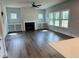 Spacious living room with a fireplace, built-in bookshelves, and large windows at 33 Macy Cir, Wendell, NC 27591