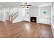 Bright living room showcasing a fireplace, built-in cabinets, and a staircase at 33 Macy Cir, Wendell, NC 27591