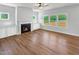 Bright living room featuring a fireplace, built-in cabinets, and ample windows offering natural light at 33 Macy Cir, Wendell, NC 27591