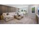 Cozy living room featuring a large sectional sofa, stylish decor, and lots of natural light at 33 Macy Cir, Wendell, NC 27591