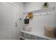 Bright mudroom featuring a built-in bench, hooks, shelf, adjacent to front door entryway at 33 Macy Cir, Wendell, NC 27591