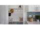 Organized mudroom area with built-in bench, hooks, shelf, and decor with stylish wall accents at 33 Macy Cir, Wendell, NC 27591