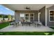 A well-furnished covered patio offers a comfortable outdoor living space with ample seating and relaxing views at 33 Macy Cir, Wendell, NC 27591