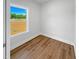 Bright, vacant room featuring hardwood flooring, a large window, and a fresh, neutral color palette at 33 Macy Cir, Wendell, NC 27591