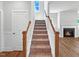 Bright staircase with a window at the landing and a fireplace in the living room at 33 Macy Cir, Wendell, NC 27591