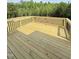 New wooden back deck features metal railings and views of the wooded lot at 40 Sunrise Ct, Spring Hope, NC 27882