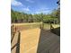 New wooden back deck features metal railings and views of the wooded lot at 40 Sunrise Ct, Spring Hope, NC 27882