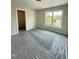 Bedroom featuring neutral paint, carpet, and window looking out to the yard at 40 Sunrise Ct, Spring Hope, NC 27882