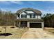 Charming two-story home with a two-car garage, stone accents, and a covered front porch at 40 Sunrise Ct, Spring Hope, NC 27882