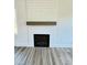 Close-up of modern electric fireplace with shiplap surround and wood-look floors at 40 Sunrise Ct, Spring Hope, NC 27882