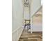 Hallway with high ceilings, wood-look floors, wainscoting, and stairs to the second story at 40 Sunrise Ct, Spring Hope, NC 27882