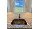 Stainless steel kitchen sink features a granite countertop, modern faucet and window view at 40 Sunrise Ct, Spring Hope, NC 27882