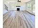 Living room with modern fireplace, wood-look floors, and staircase to the second story at 40 Sunrise Ct, Spring Hope, NC 27882