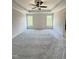 Large main bedroom with tray ceiling, ceiling fan, and two large windows at 40 Sunrise Ct, Spring Hope, NC 27882