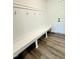 Mud room features luxury vinyl plank flooring, bench, and wainscoting wall at 40 Sunrise Ct, Spring Hope, NC 27882