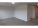 Bedroom with neutral carpet and neutral paint color; door leads to other rooms at 73 High Hampton Way, Fuquay Varina, NC 27526