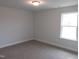Bedroom with carpet, neutral paint color, and window allowing for natural light at 73 High Hampton Way, Fuquay Varina, NC 27526