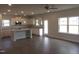 Open-concept kitchen with white cabinets, stainless steel appliances, and island at 73 High Hampton Way, Fuquay Varina, NC 27526