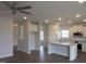 Open concept kitchen with white cabinets, stainless steel appliances, and a large center island at 73 High Hampton Way, Fuquay Varina, NC 27526