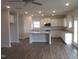 Open concept kitchen with white cabinets, stainless steel appliances, and a center island at 73 High Hampton Way, Fuquay Varina, NC 27526