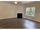 Living room featuring a fireplace and a large window at 73 High Hampton Way, Fuquay Varina, NC 27526